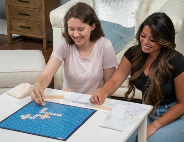 Two girls playing Flip Words at table
